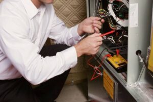 HVAC technician repairing a furnace