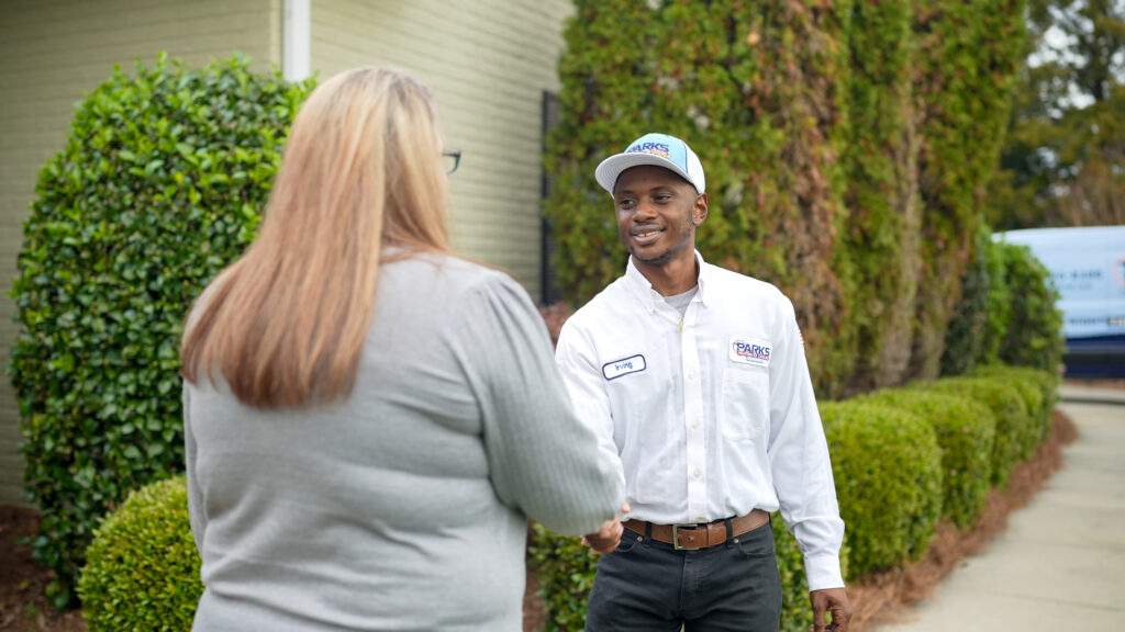 Parks technician greeting a homeowner outside their home