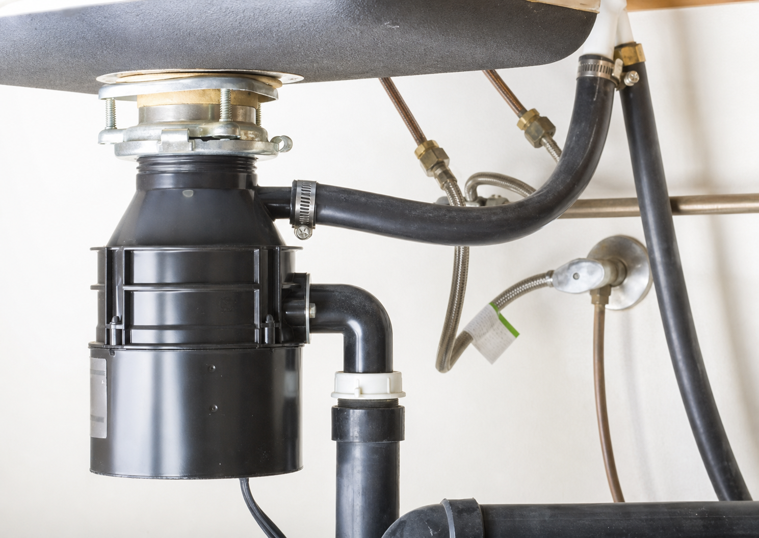Under the sink garbage disposal unit.